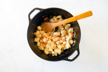 chicken for chicken and dumplings in a pot with a wood spoon