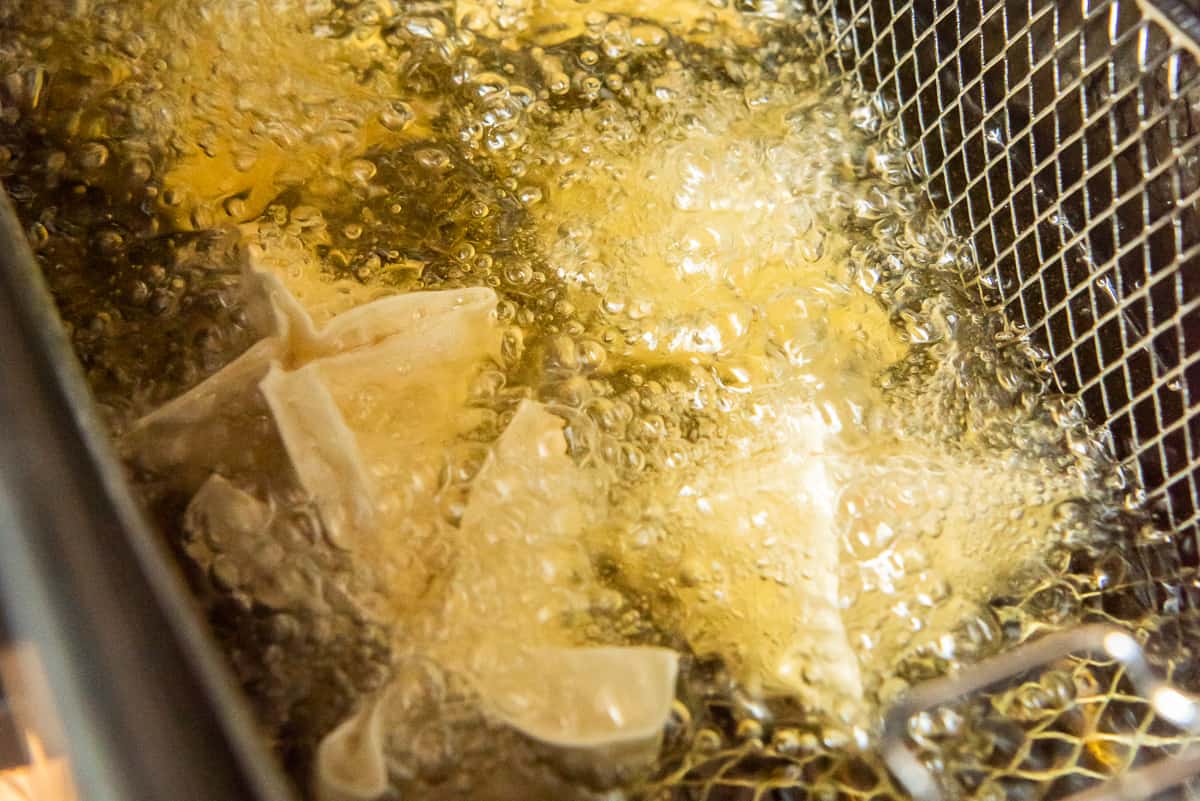 Frying the wontons in oil. - 10