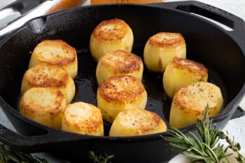 fondant potatoes in a skillet before adding herbs and broth