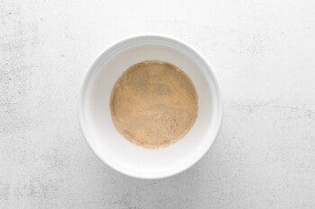 ingredients for parker house rolls in a white bowl