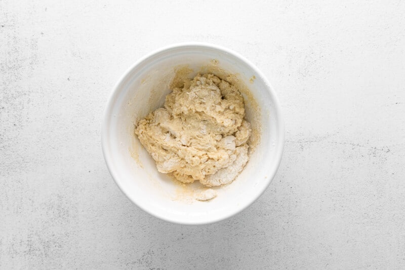 dough for parker house rolls in a white bowl before rising