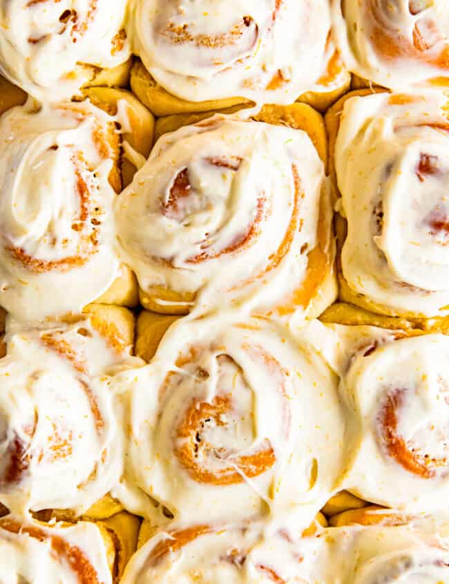 frosted orange rolls in baking dish