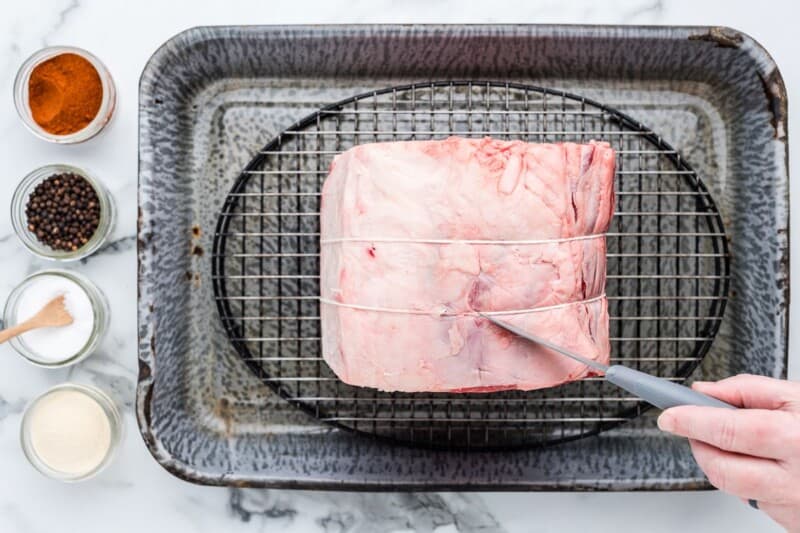 uncooked prime rib in a baking pan