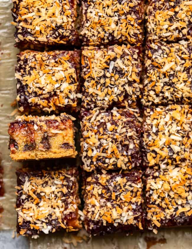 overhead image of raspberry chocolate coconut bars on parchment paper