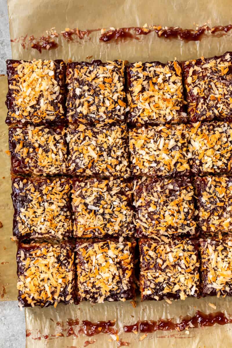 overhead image of raspberry chocolate coconut bars on parchment paper