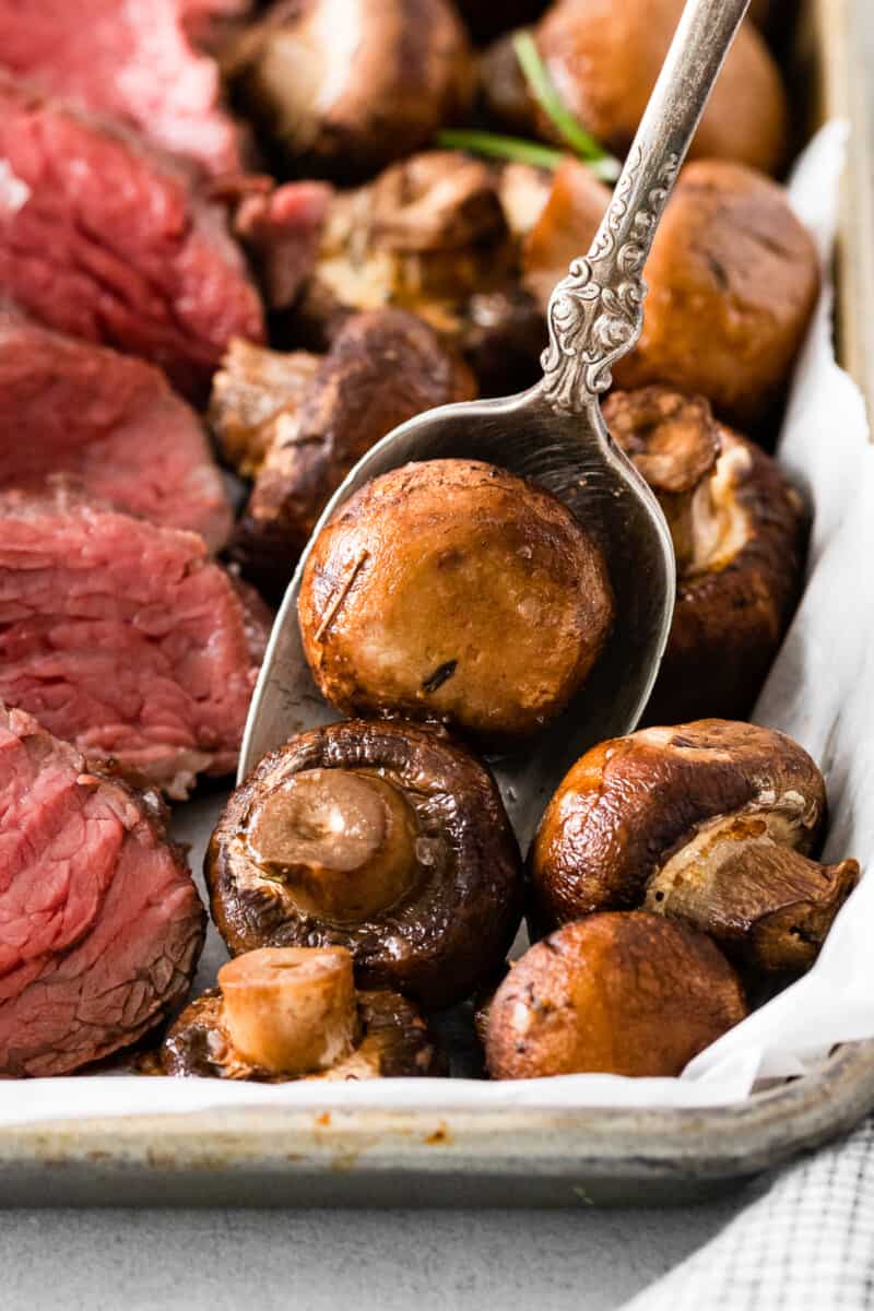 serving spoon with roasted mushrooms