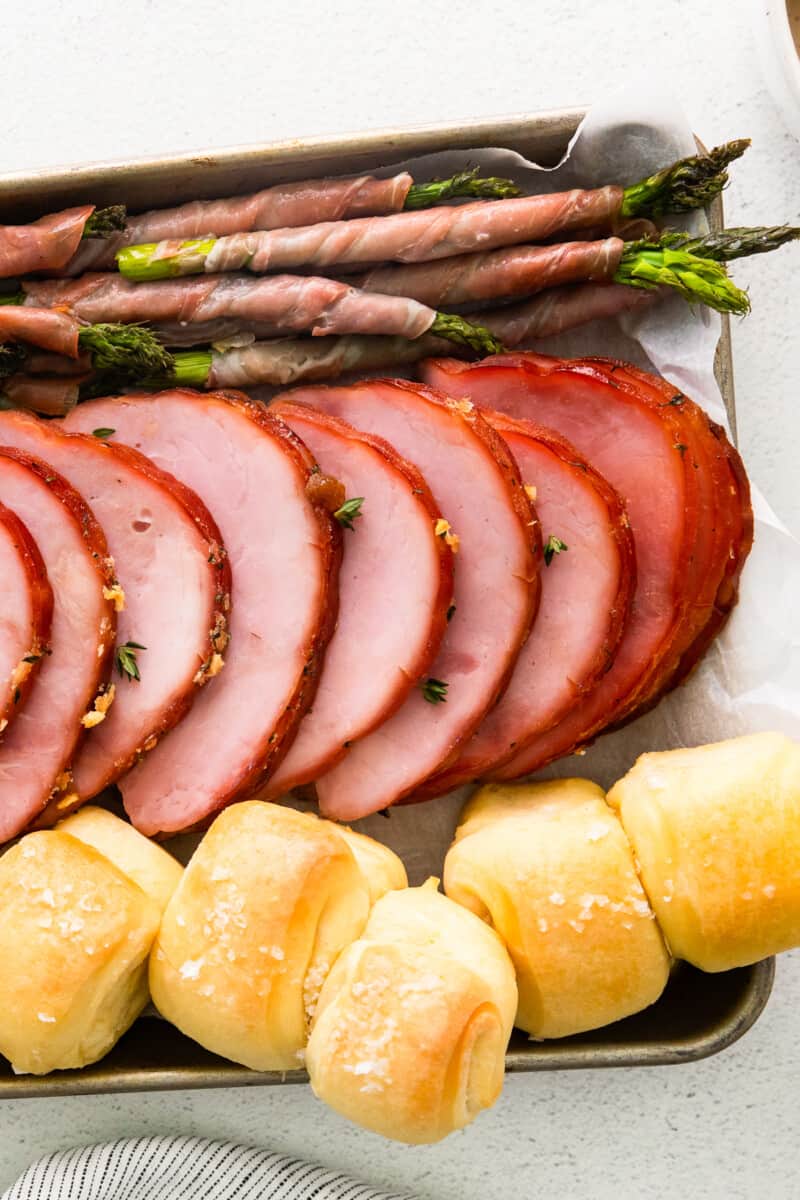 christmas ham dinner on a baking sheet.