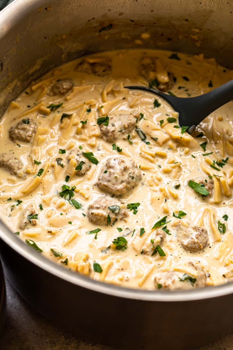 swedish meatball soup in a pot with a ladle