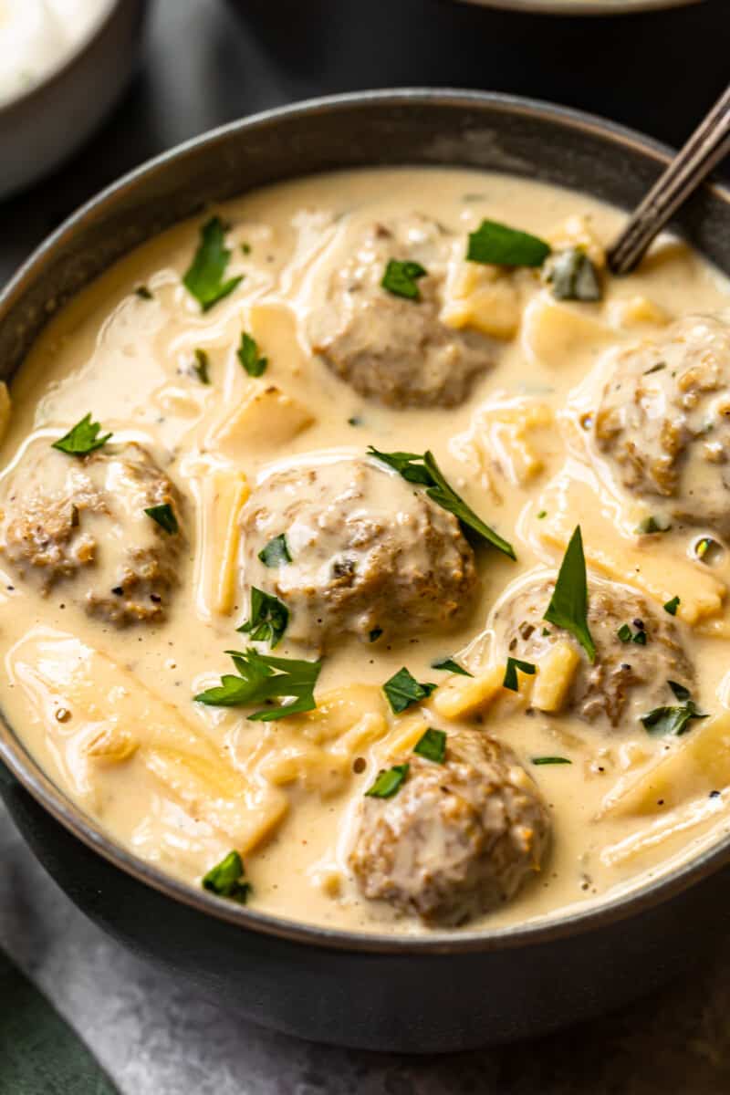 swedish meatball soup in a black bowl