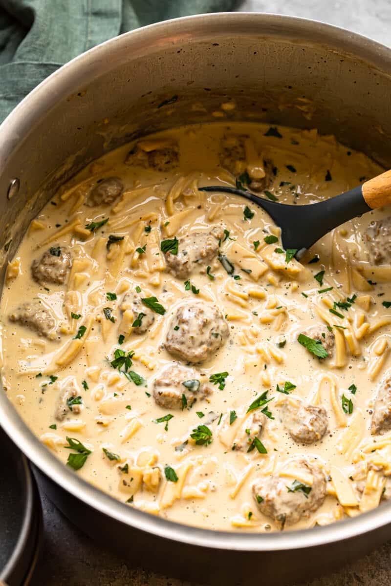 swedish meatball soup in a pot with a ladle
