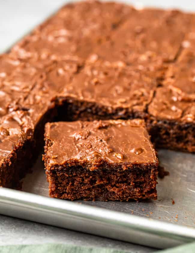 texas sheet cake in a shet pan with a square cut