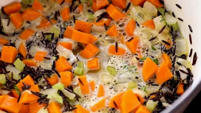 rice and vegetables simmering in a large pot