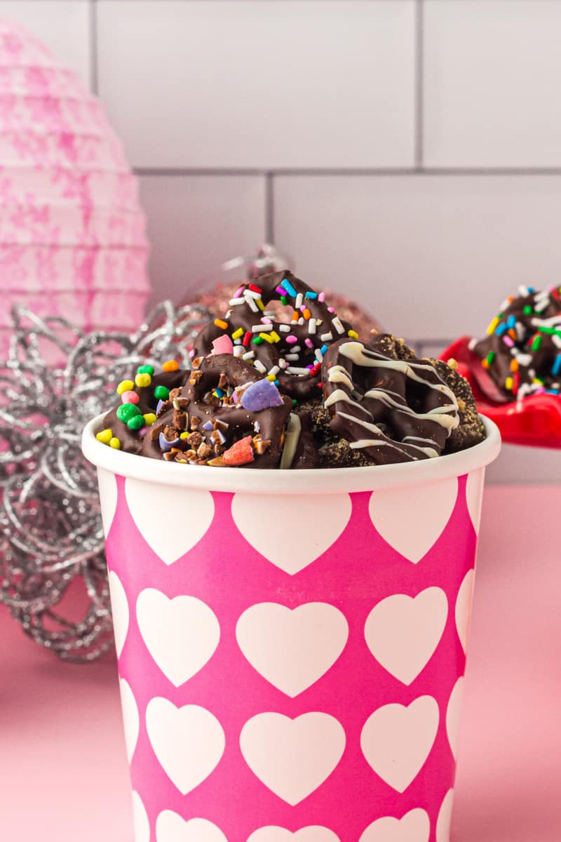 chocolate covered pretzels in a pink and white container