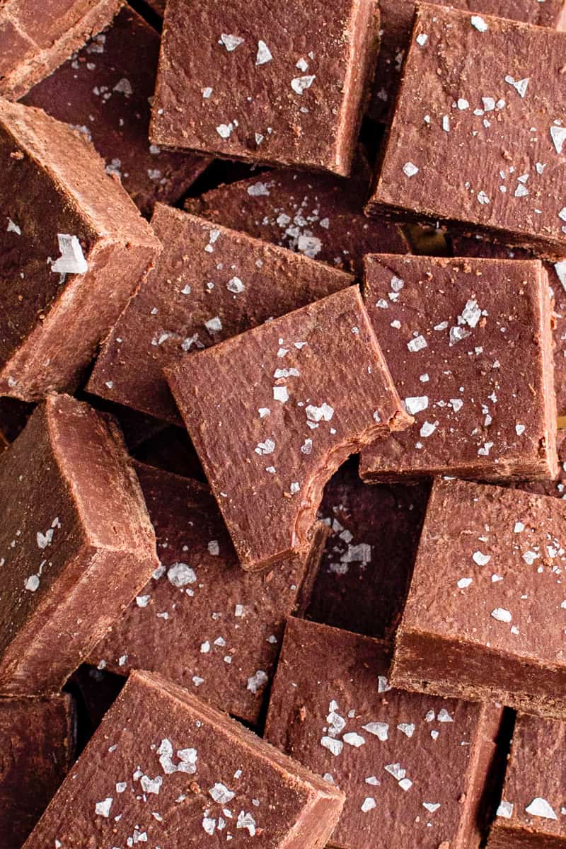 squares of chocolate fudge with a bite taken from one