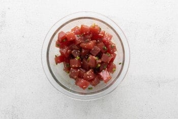 seasoned tuna chunks in a glass bowl.
