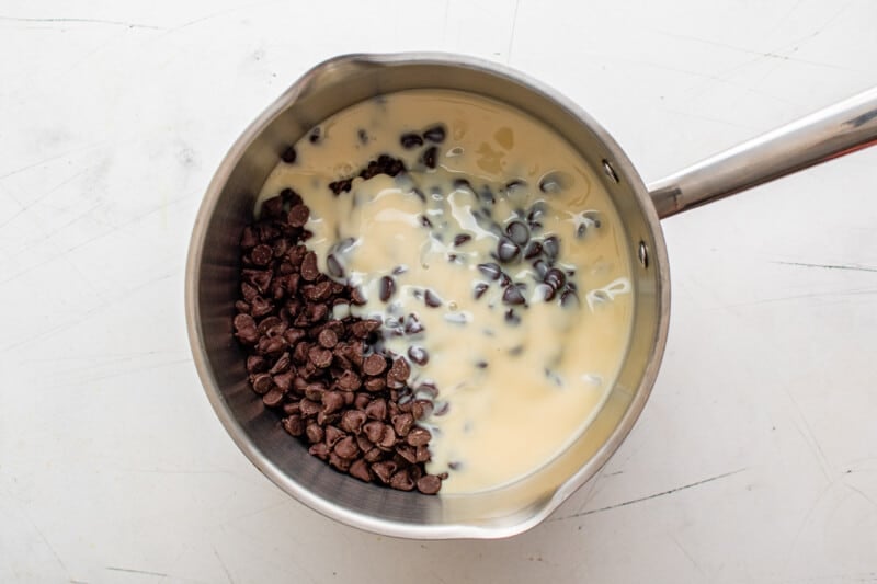chocolate chips and sweetened condensed milk in a saucepan