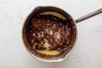 partially melted chocolate chips with butter and vanilla extract in a saucepan
