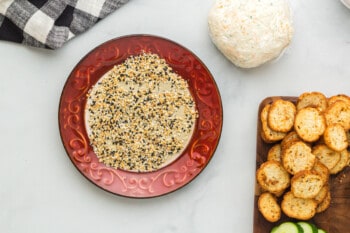 everything bagel seasoning on a red and cream plate