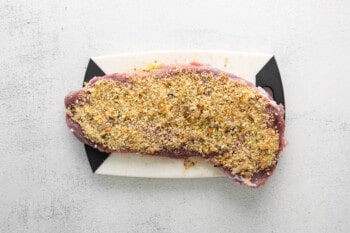 flattened pork loin with a layer of breadcrumb filling spread on top