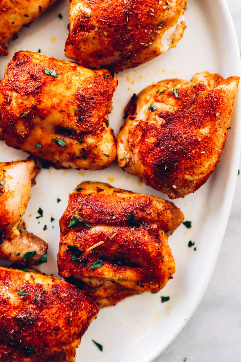 baked chicken thighs on a white serving tray