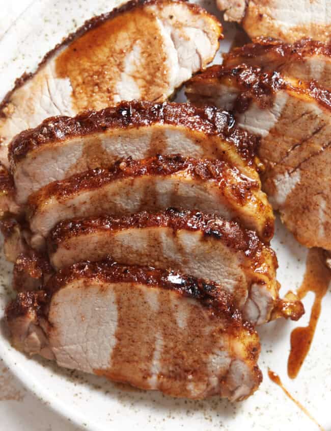 baked pork tenderloin on a white plate.