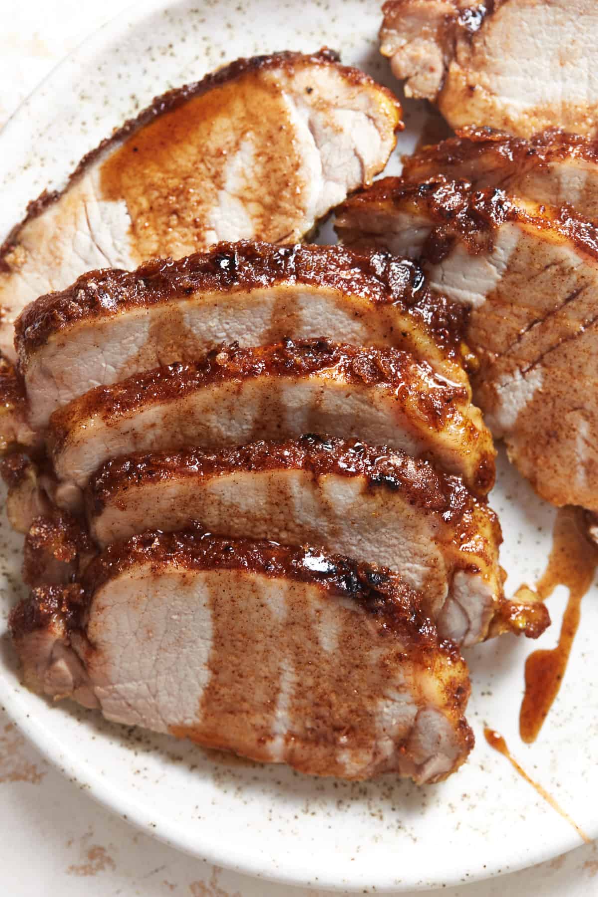 baked pork tenderloin on a white plate.