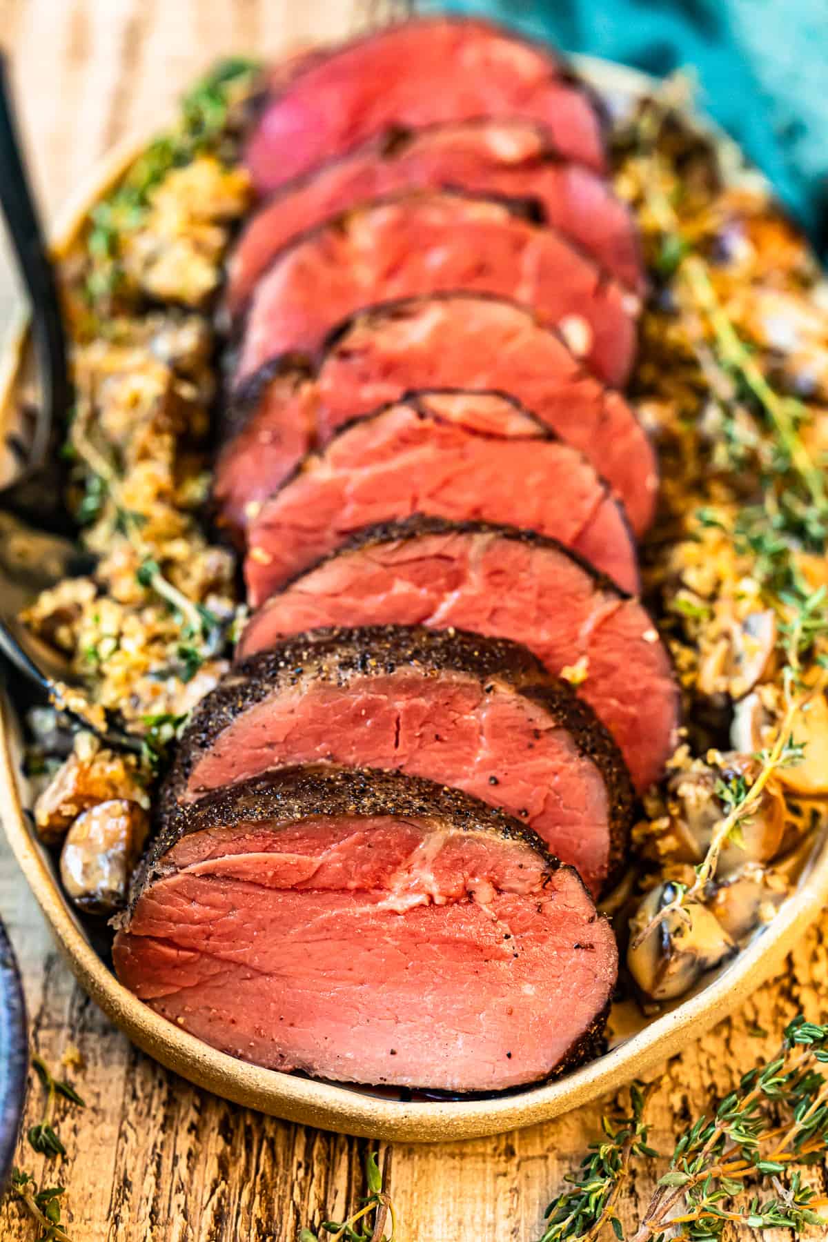 slices of beef tenderloin on a white serving platter