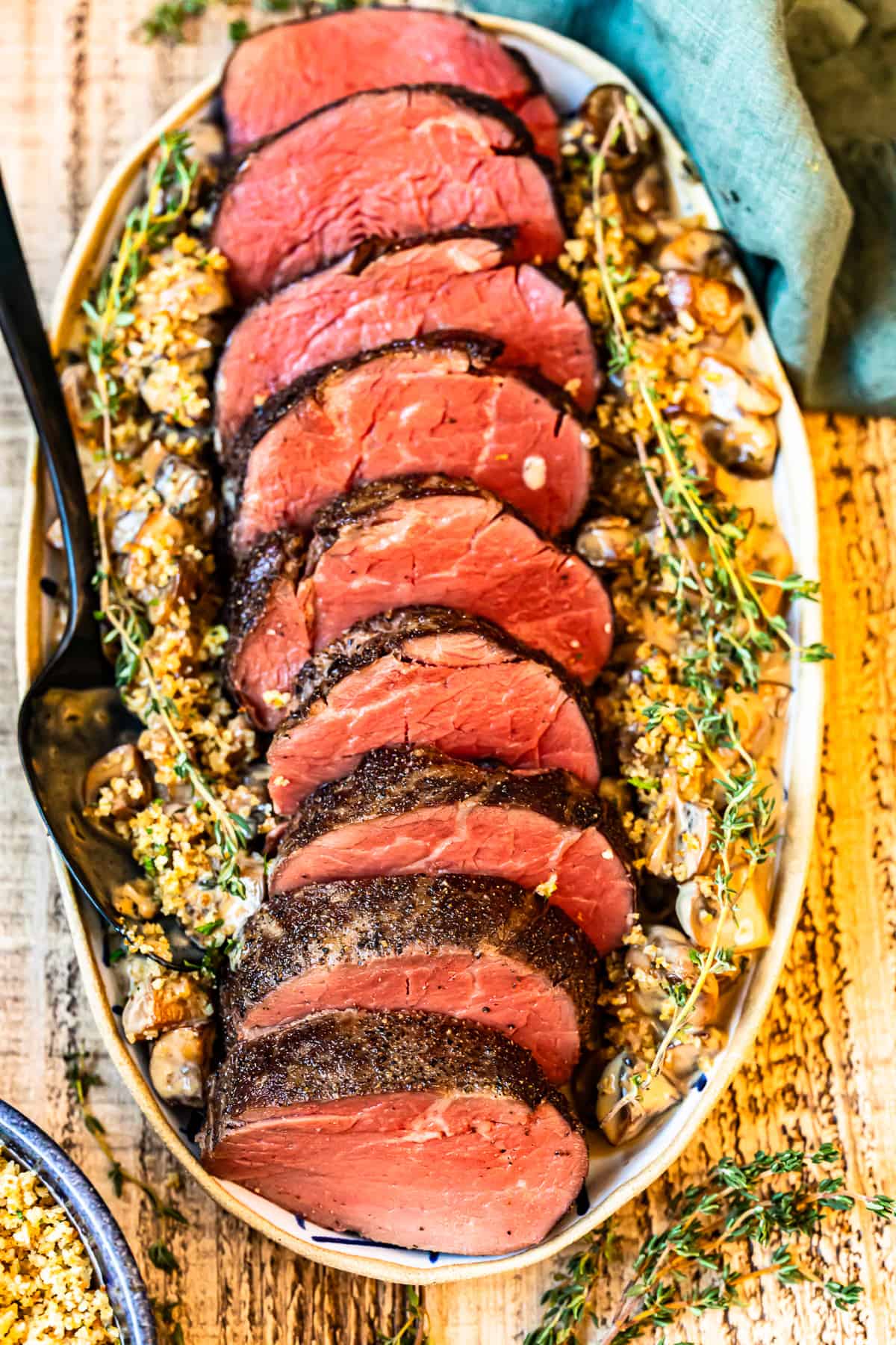 slices of beef tenderloin on a white serving platter