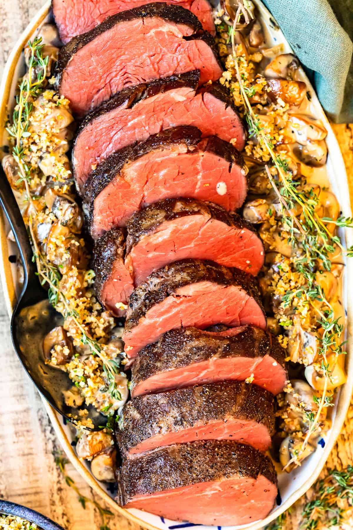 slices of beef tenderloin on a white serving platter