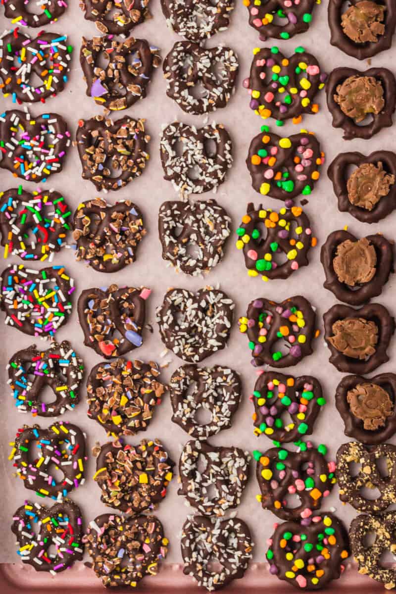 overhead image of chocolate covered pretzels with toppings