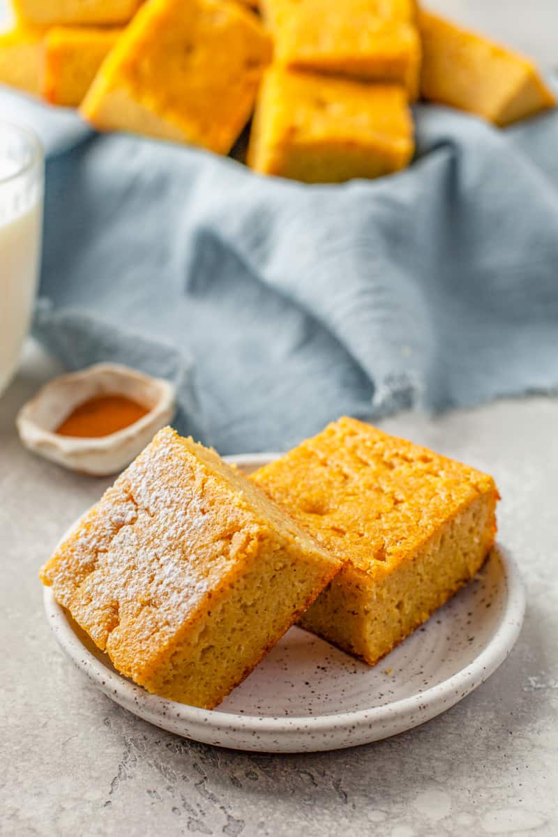 2 pieces of cornbread on a white plate