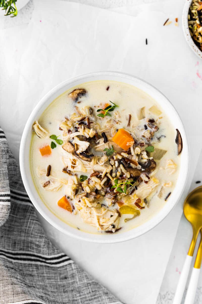 overhead image of crockpot chicken wild rice soup in a white bowl