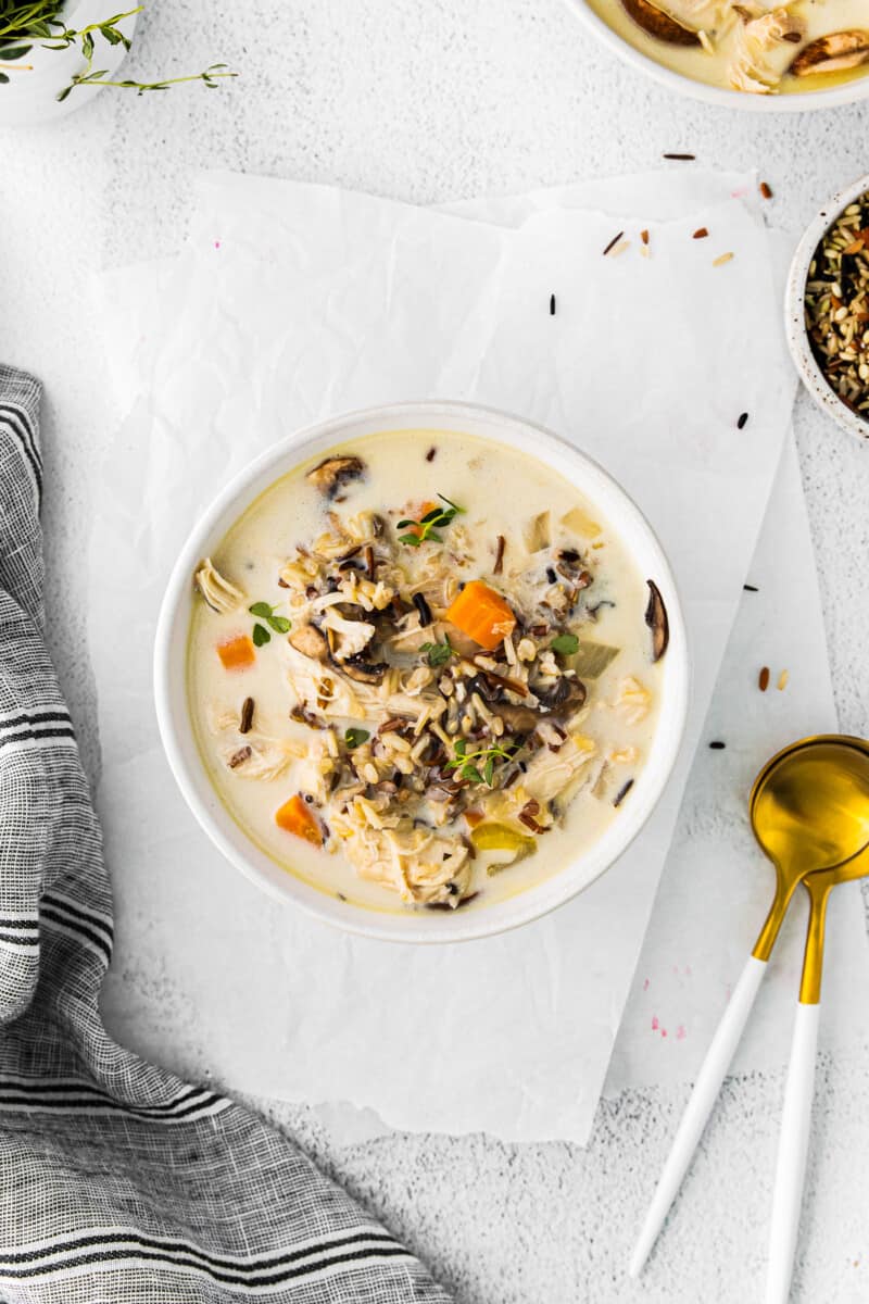 overhead image of crockpot chicken wild rice soup in a white bowl