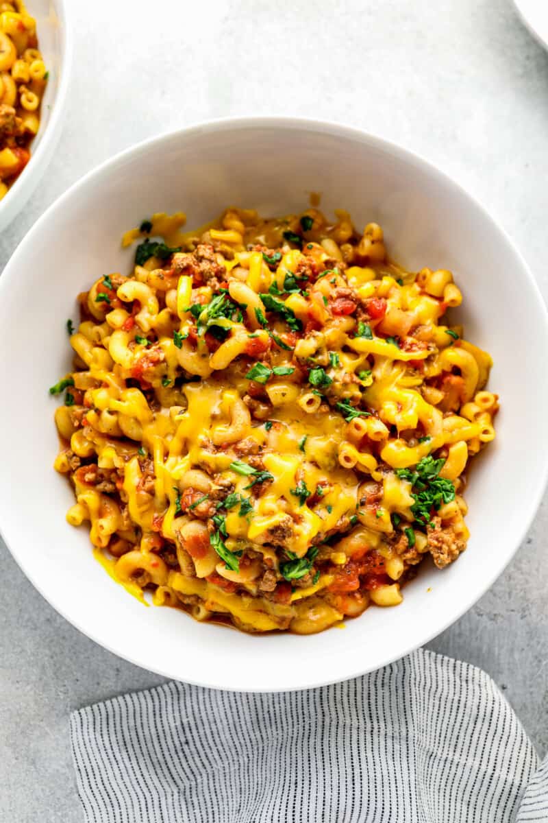 bowl of cheesy crockpot goulash on table