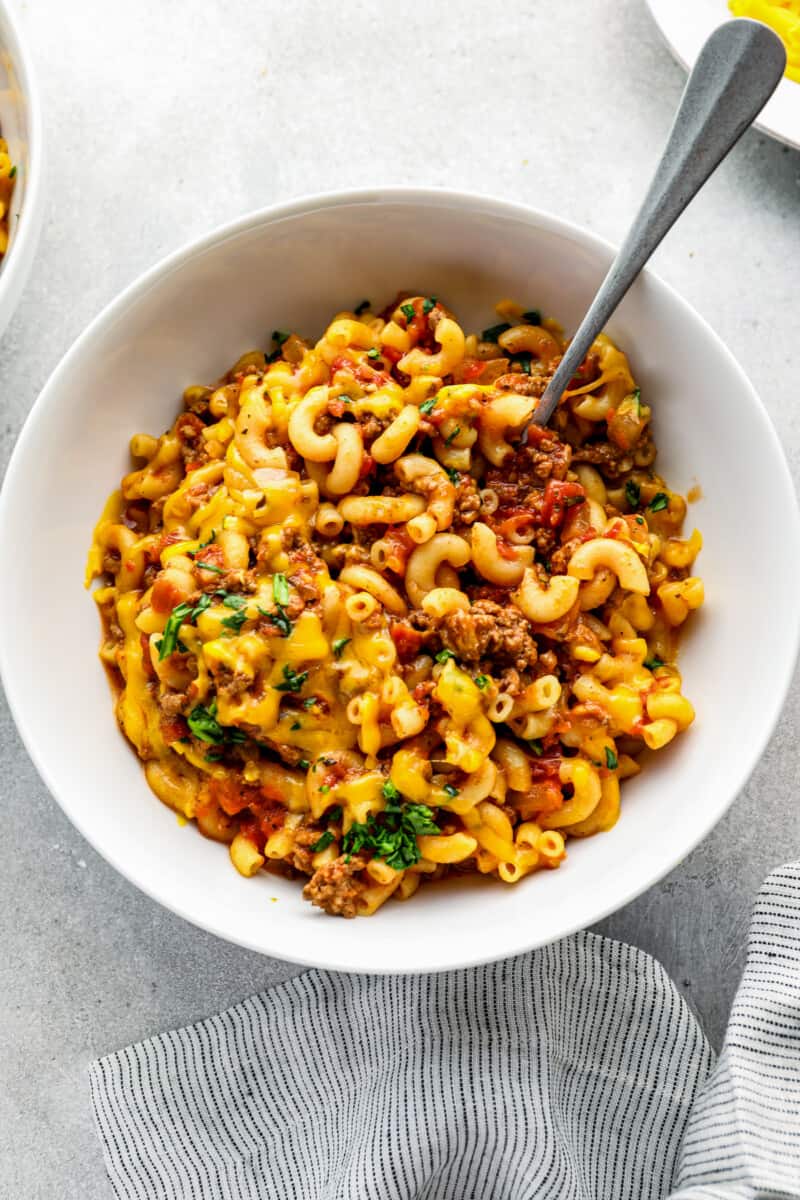 spoon in bowl of crockpot american goulash