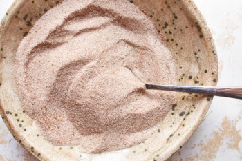 spice rub for baked pork tenderloin in a white bowl with a spoon.