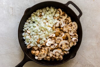diced onion and sliced mushrooms in a skillet before cooking