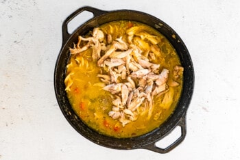 shredded chicken added to pot of soup