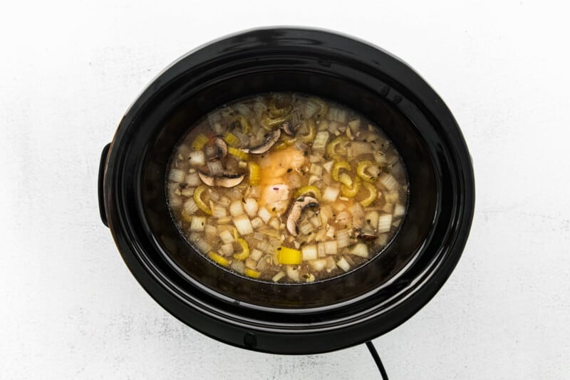 broth, veggies, rice, and chicken in a crockpot