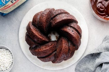 hot chocolate bundt cake after baking without toppings on a white serving tray