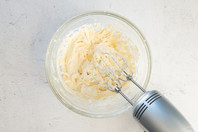 oatmeal cream pie filling in a glass bowl with a hand mixer