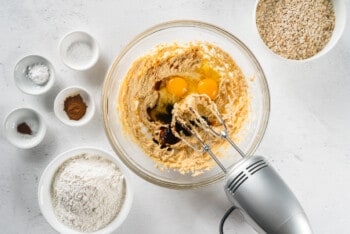 wet ingredients for oatmeal cream pies in a glass bowl with a hand mixer