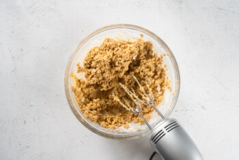 oatmeal cream pie cookie dough in a glass bowl with a hand mixer