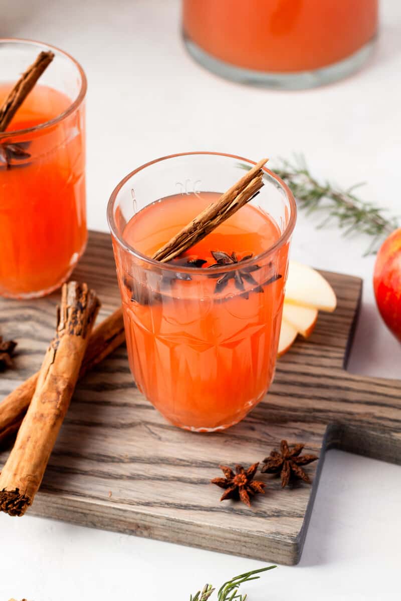 glass of instant pot apple cider with cinnamon stick