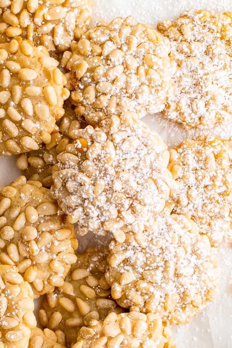 overhead image of pignoli cookies with a dusting of powdered sugar