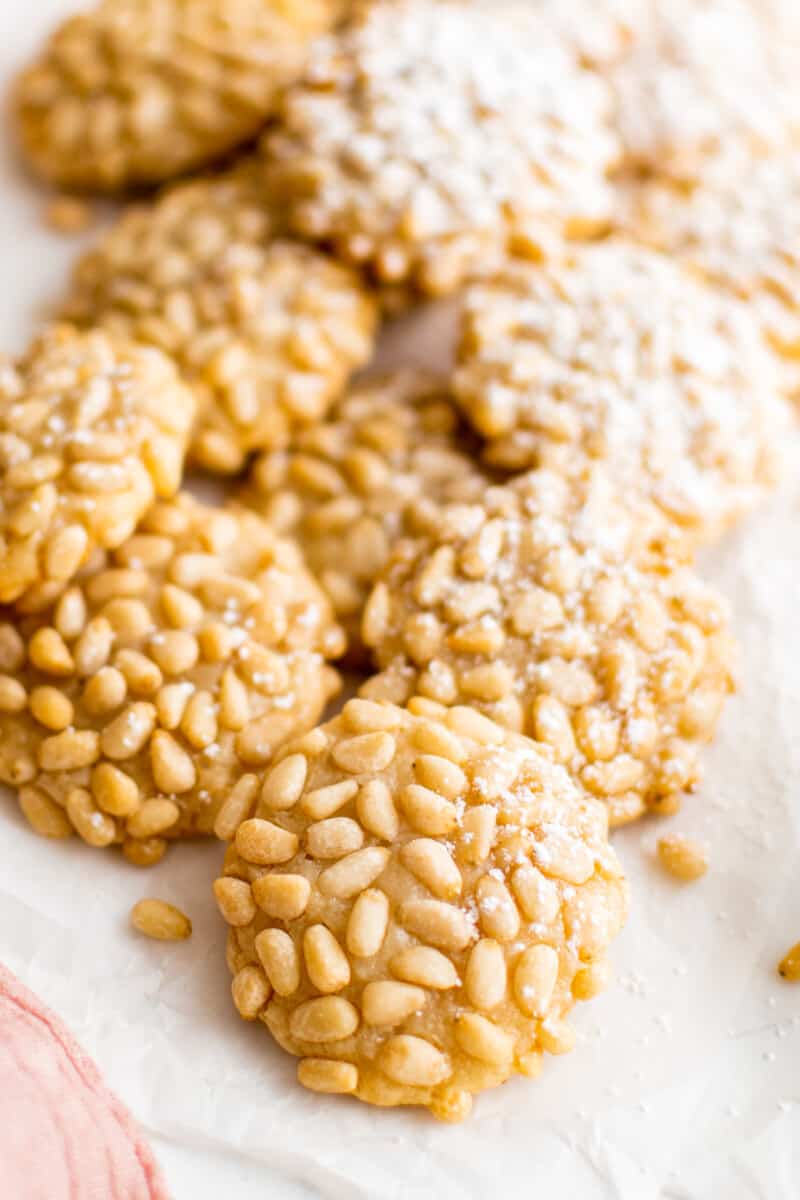 pignoli cookies on a white serving tray