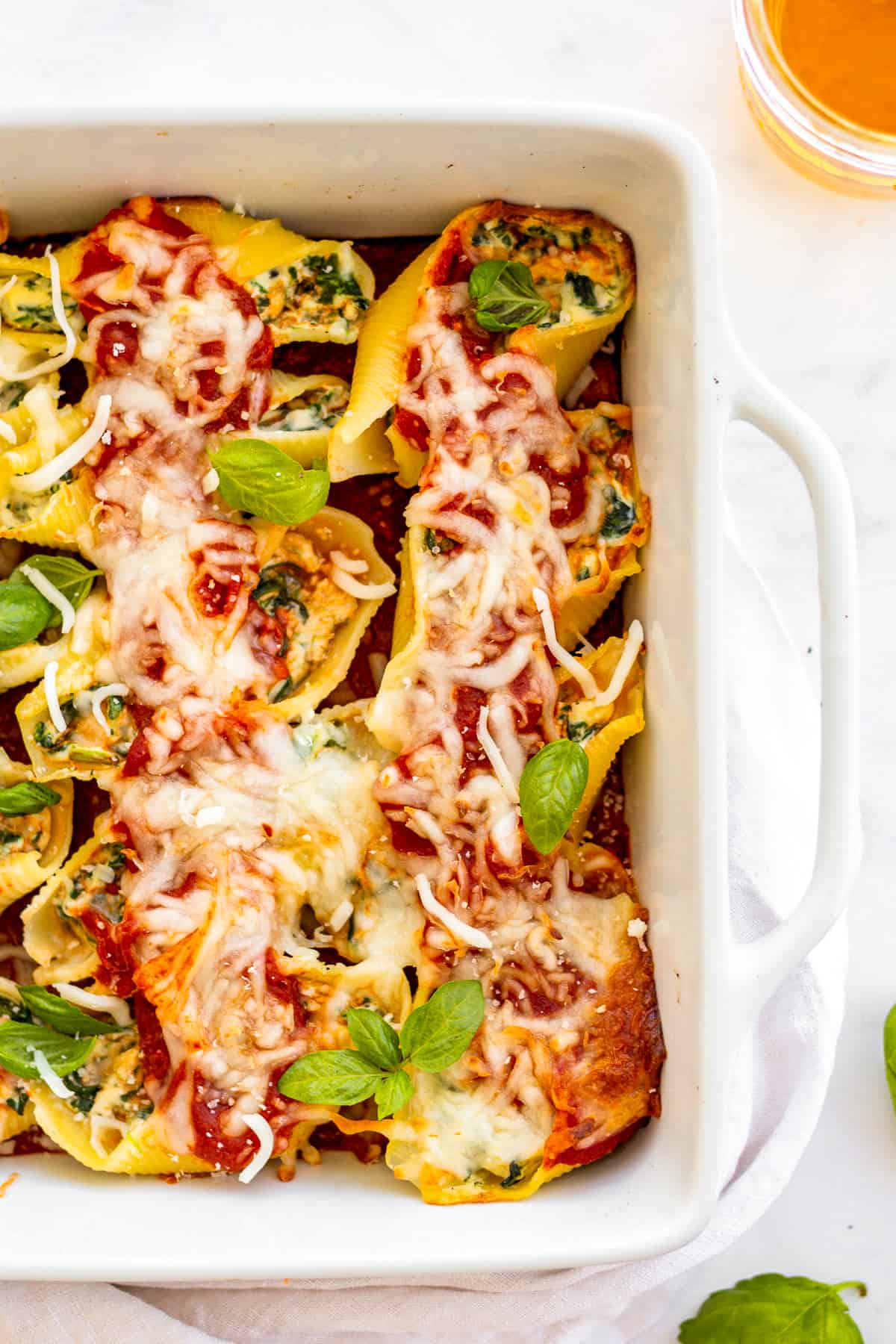 dish of stuffed shells with spinach.