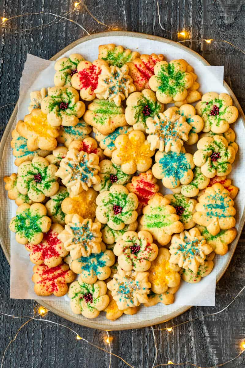 spritz cookies with sprinkles on a white serving platter