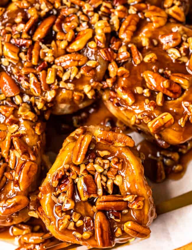 caramel pecan sticky buns on a white serving tray