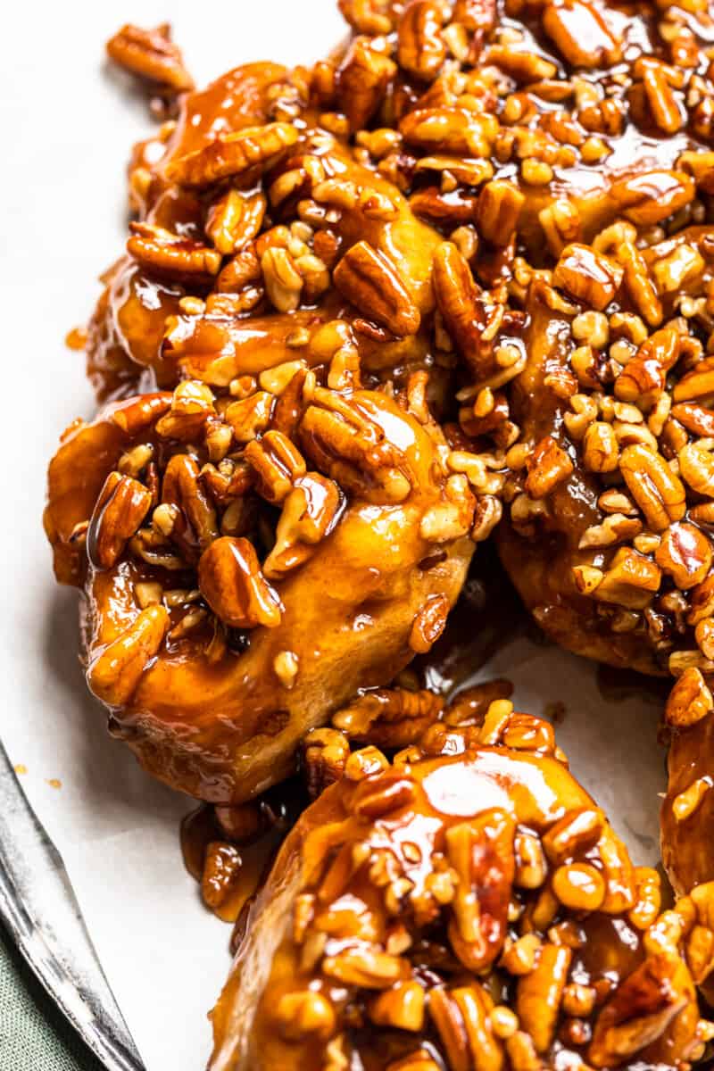 caramel pecan sticky buns on a white serving tray